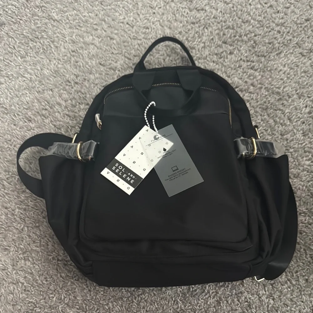 Sleek Black Backpack with Gold Zippers